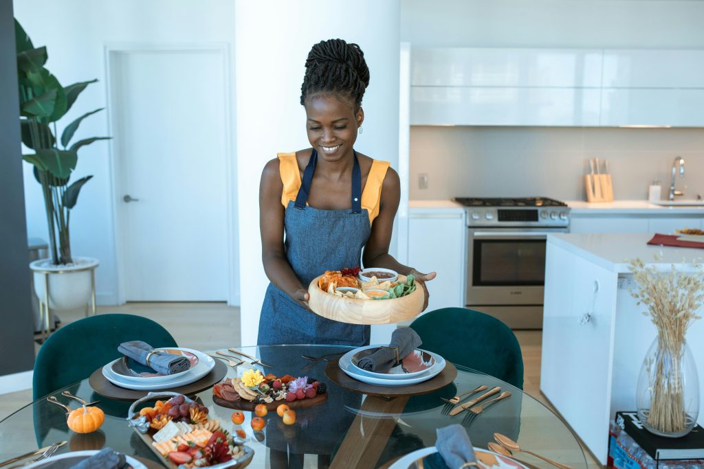 Hostess preparing for her event with food and beverages.